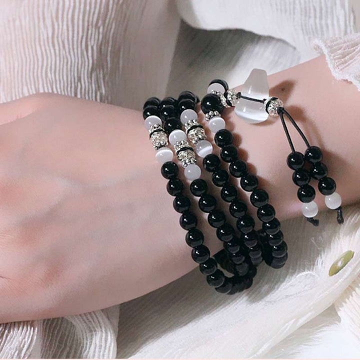 Bracelet de méditation en perles de cristal blanc et onyx noir Buddha Stones
