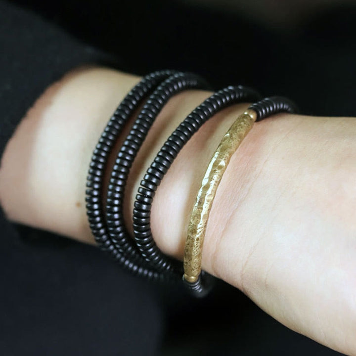 Bracelet multicouches en bois d'ébène et cuivre avec Buddha Stones