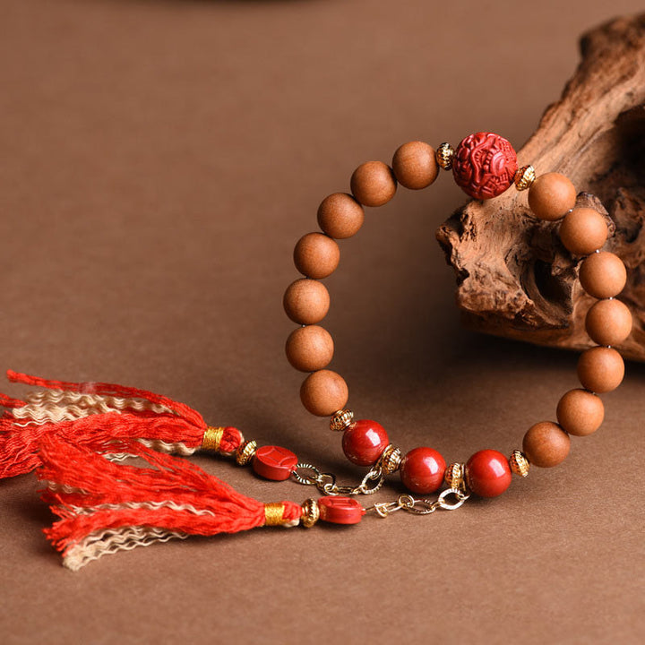 Bracelet Buddha Stones en bois de pêche et cinabre naturel avec pompons de richesse PiXiu