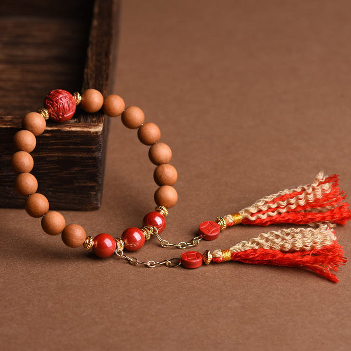 Bracelet Buddha Stones en bois de pêche et cinabre naturel avec pompons de richesse PiXiu