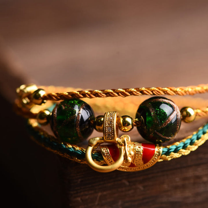 Bracelet de guérison multicouche tressé en perles de verre Liuli en corde tibétaine faite à la main avec Buddha Stones