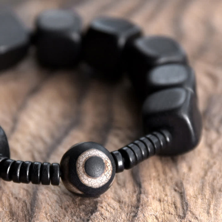 Bracelet de force en perles dzi en bois d'ébène tibétain avec Buddha Stones