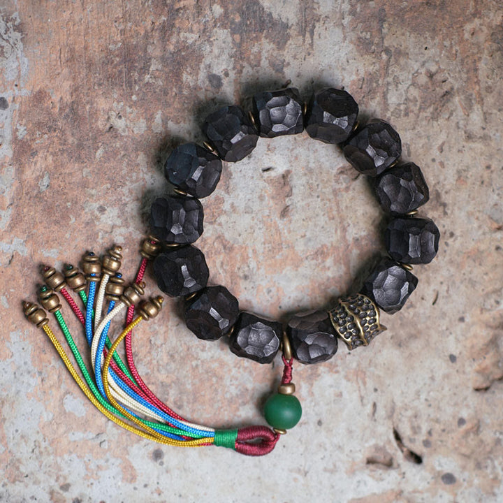 Bracelet Mala en bois d'ébène et cuivre avec Buddha Stones et pompon de paix