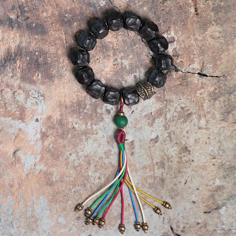 Bracelet Mala en bois d'ébène et cuivre avec Buddha Stones et pompon de paix