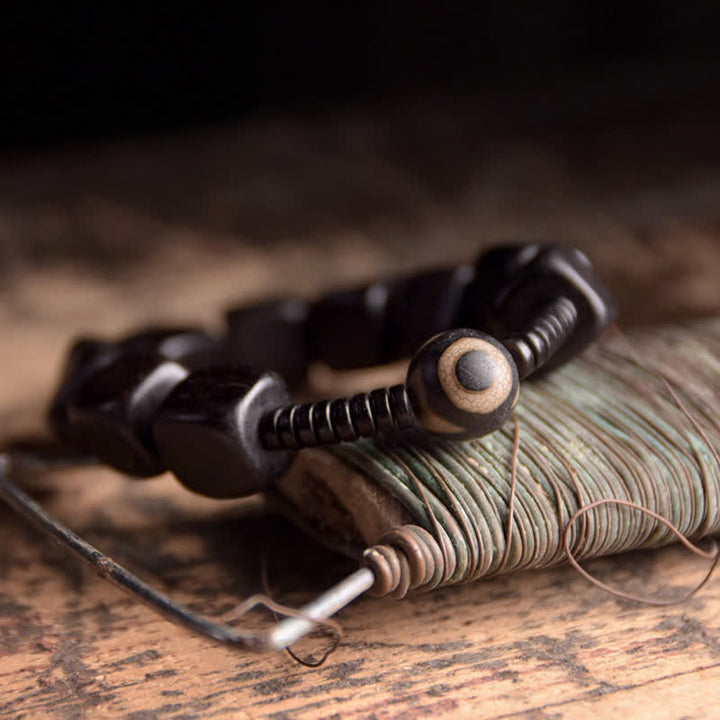 Bracelet de force en perles dzi en bois d'ébène tibétain avec Buddha Stones