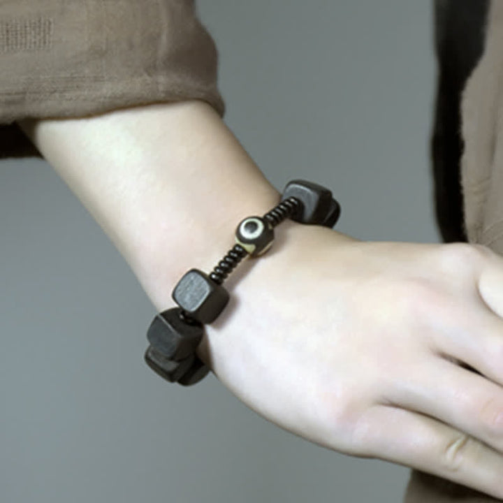 Bracelet de force en perles dzi en bois d'ébène tibétain avec Buddha Stones