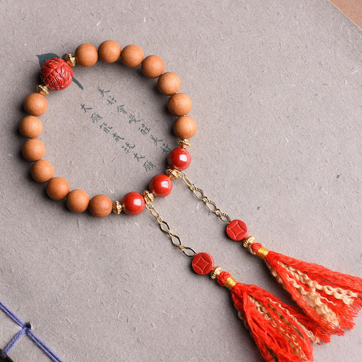 Bracelet Buddha Stones en bois de pêche et cinabre naturel avec pompons de richesse PiXiu