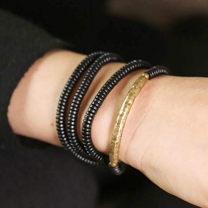 Bracelet multicouches en bois d'ébène et cuivre avec Buddha Stones