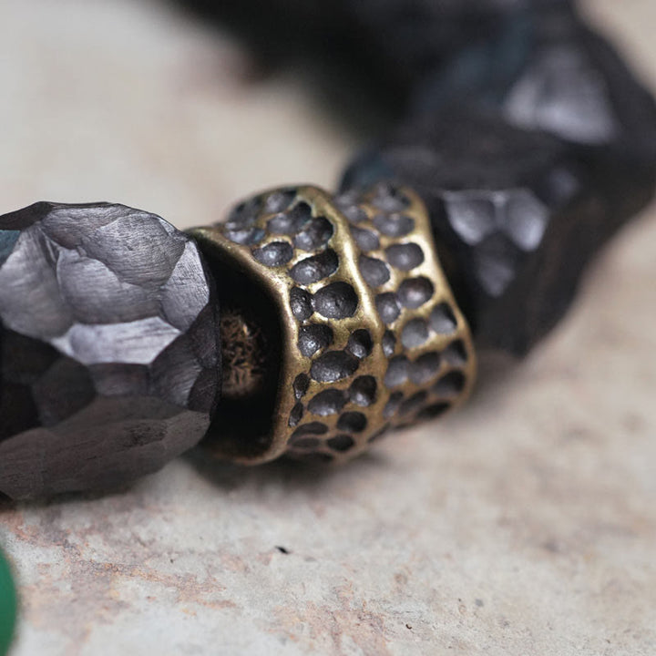 Bracelet Mala en bois d'ébène et cuivre avec Buddha Stones et pompon de paix