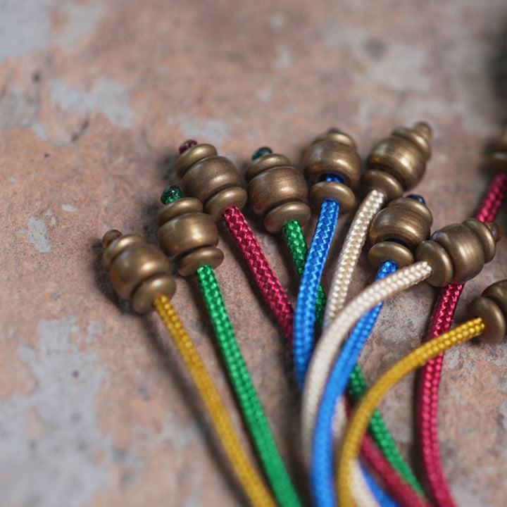 Bracelet Mala en bois d'ébène et cuivre avec Buddha Stones et pompon de paix