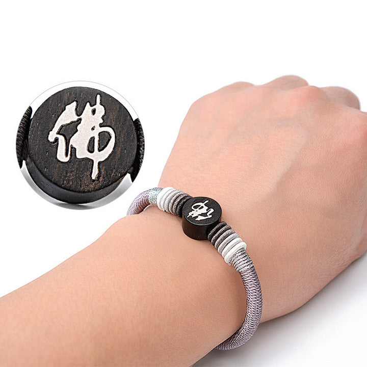 Bracelet en corde fait main en ébène avec personnage de Bouddha de Buddha Stones