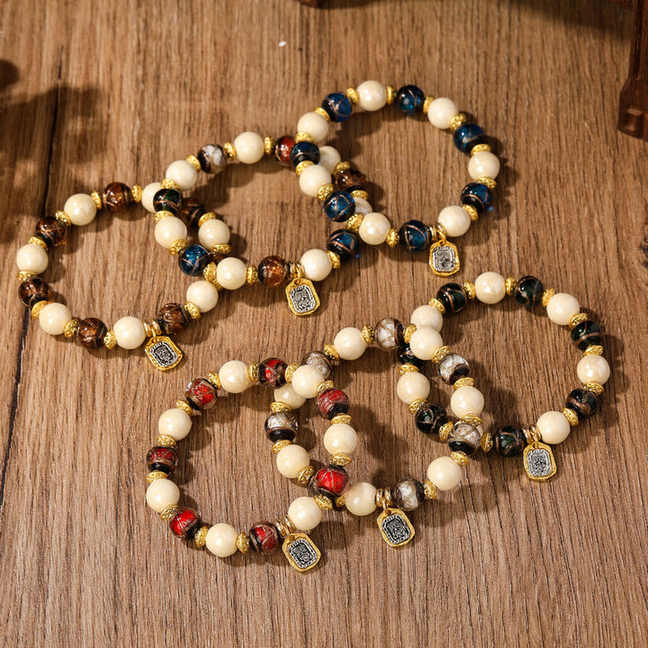 Bracelet de protection en perles de porcelaine en cendres et en verre Liuli avec breloque en Buddha Stones et déesse de la richesse tibétaine Zakiram