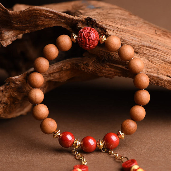Bracelet Buddha Stones en bois de pêche et cinabre naturel avec pompons de richesse PiXiu
