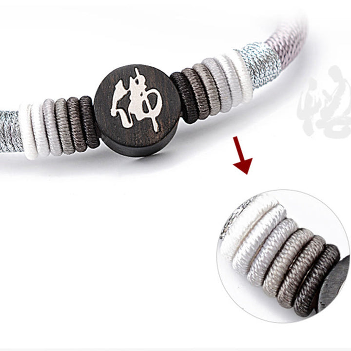 Bracelet en corde fait main en ébène avec personnage de Bouddha de Buddha Stones