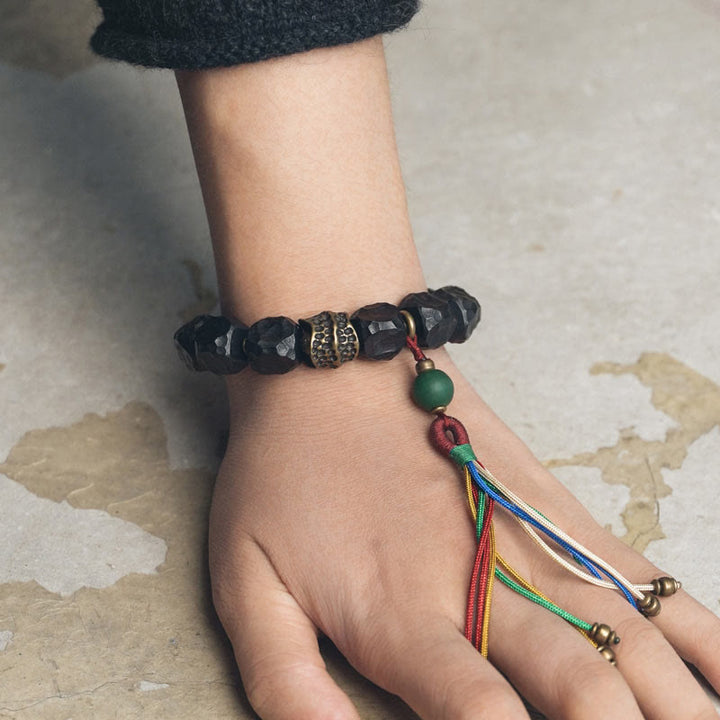 Bracelet Mala en bois d'ébène et cuivre avec Buddha Stones et pompon de paix