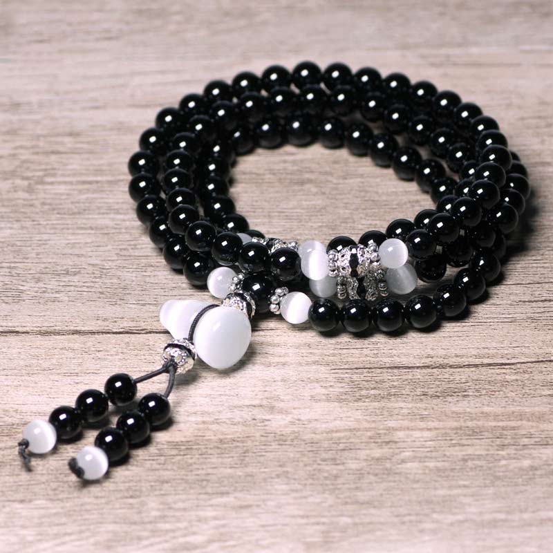 Bracelet de méditation en perles de cristal blanc et onyx noir Buddha Stones