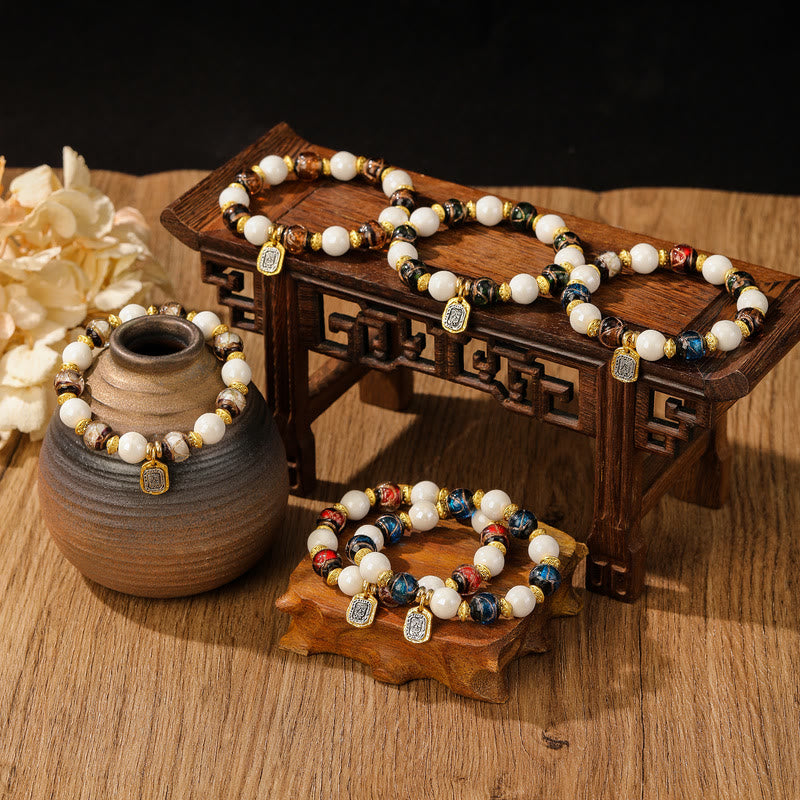 Bracelet de protection en perles de porcelaine en cendres et en verre Liuli avec breloque en Buddha Stones et déesse de la richesse tibétaine Zakiram
