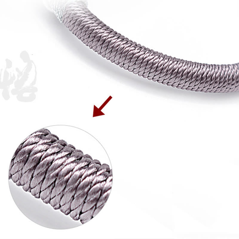 Bracelet en corde fait main en ébène avec personnage de Bouddha de Buddha Stones