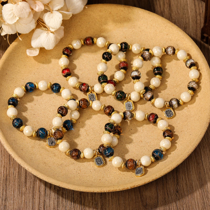 Bracelet de protection en perles de porcelaine en cendres et en verre Liuli avec breloque en Buddha Stones et déesse de la richesse tibétaine Zakiram