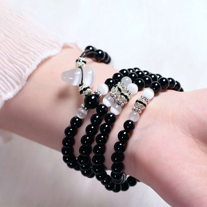 Bracelet de méditation en perles de cristal blanc et onyx noir Buddha Stones