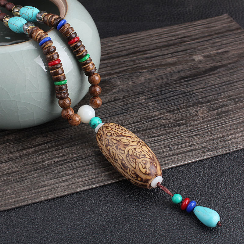Collier pendentif en Buddha Stones tibétain en bois de wengé Bodhi Seed Agate Balance Peace