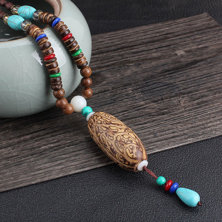 Collier pendentif en Buddha Stones tibétain en bois de wengé Bodhi Seed Agate Balance Peace