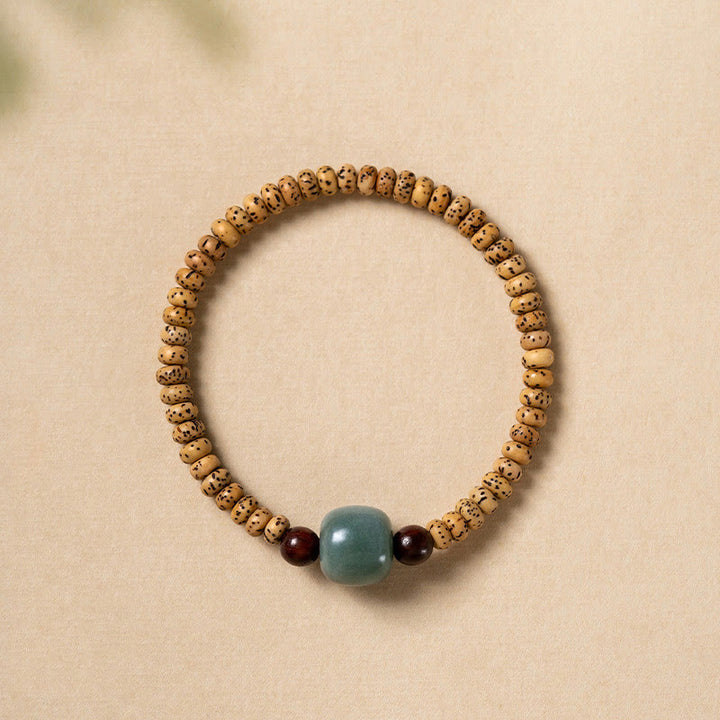 Bracelet de sagesse en bois de santal rouge à petites feuilles et Buddha Stones