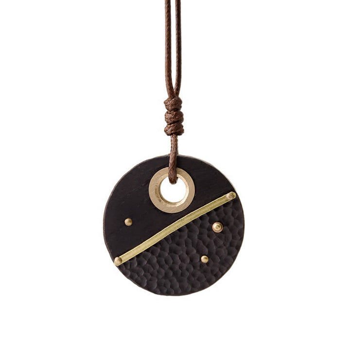 Collier pendentif en cuivre et bois d'ébène rond fabriqué à la main avec des Buddha Stones