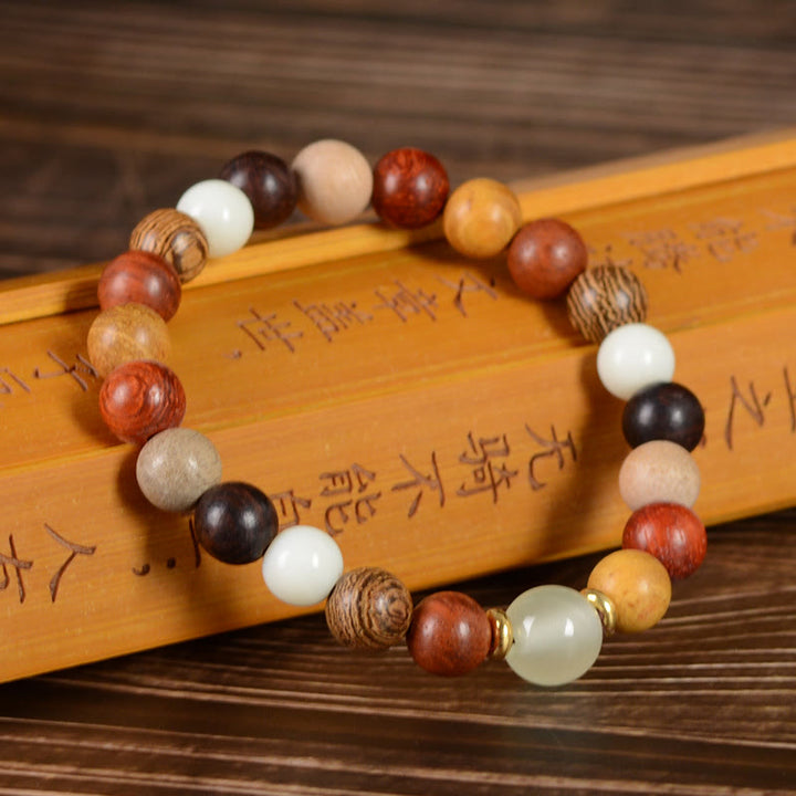 Bracelet de paix en bois de santal vert multicolore et bois d'ébène avec Buddha Stones et bois de santal rouge