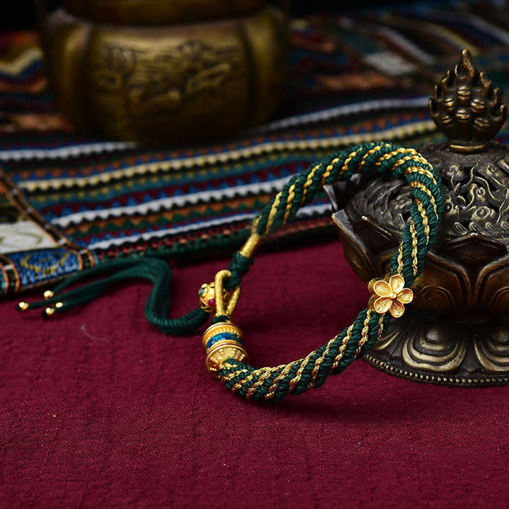 Bracelet en corde tissée avec breloque en forme de fleur et roue de prière en Buddha Stones faites à la main avec cinq dieux de la richesse et de la chance