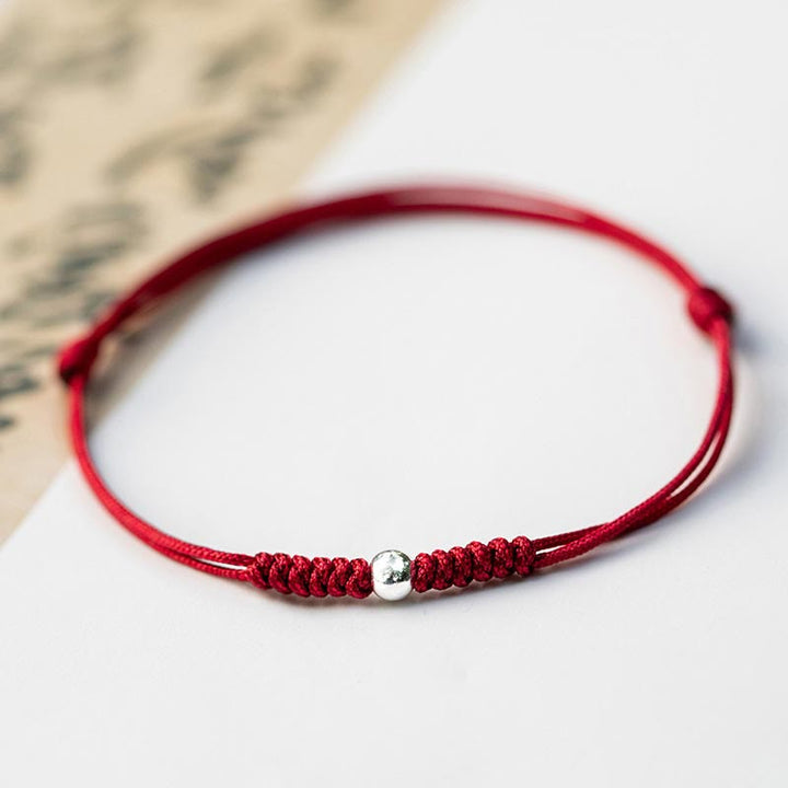 Bracelet en argent sterling 925 avec perle porte-bonheur et cordon fin tressé rouge, orné de Buddha Stones. - Perle ronde - Rouge foncé (tour de poignet 14-18 cm) - image 14