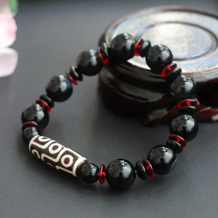 Bracelet de protection de richesse en perles dzi à neuf yeux en onyx noir de Buddha Stones