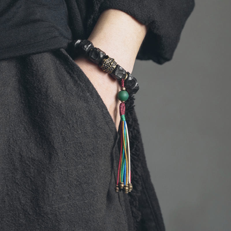 Bracelet Mala en bois d'ébène et cuivre avec Buddha Stones et pompon de paix
