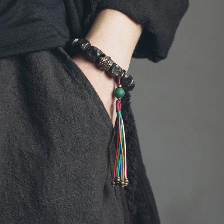 Bracelet Mala en bois d'ébène et cuivre avec Buddha Stones et pompon de paix