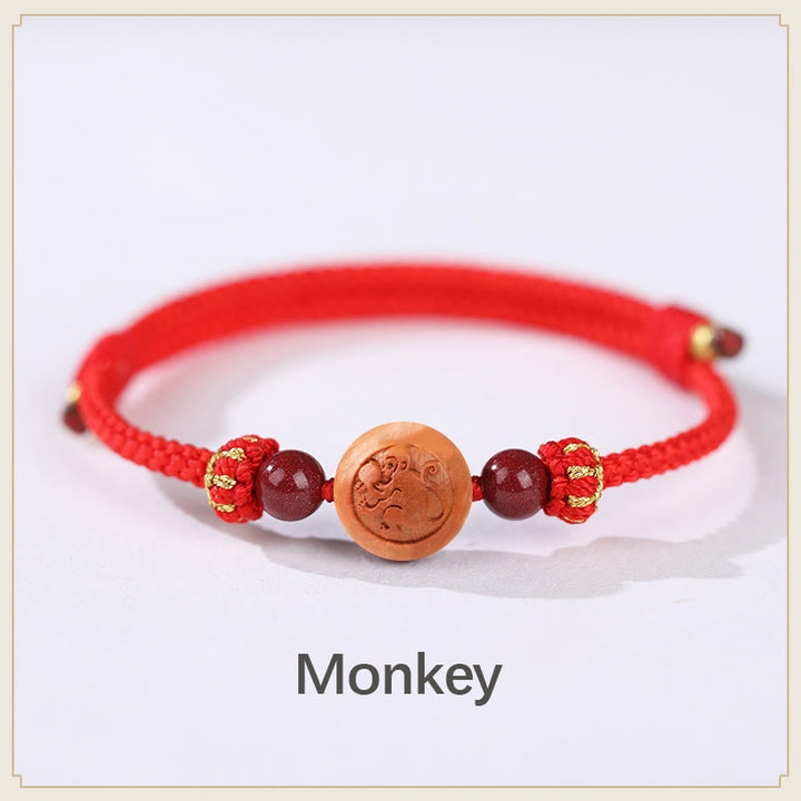 Bracelet de richesse en bois de pêche naturel Buddha Stones et caractère Fu du zodiaque chinois sculpté en cinabre