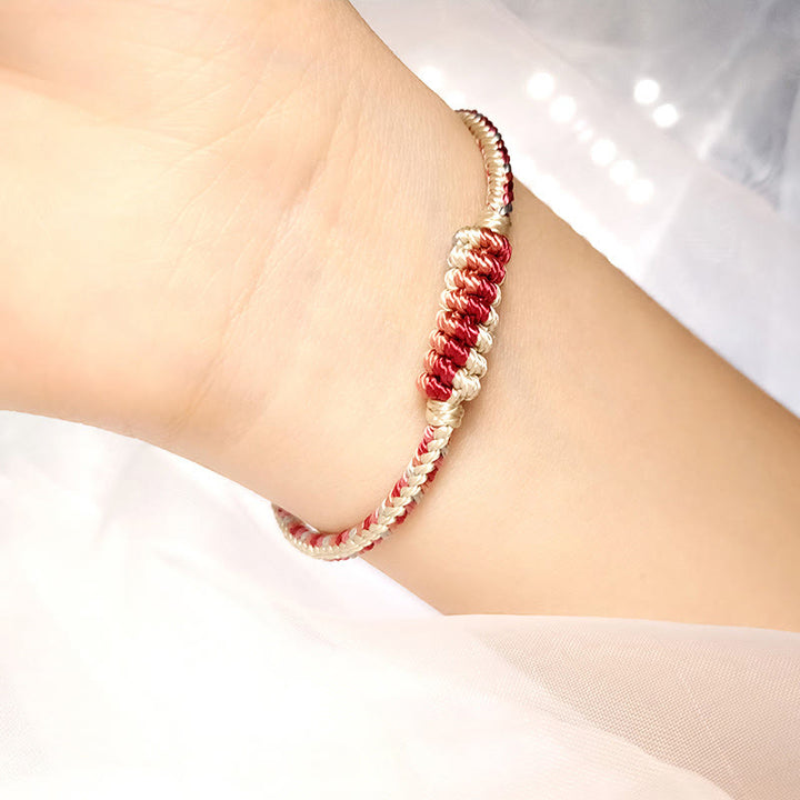 Bracelet de protection tressé à huit fils en Buddha Stones tibétain fait à la main avec roue de prière et nœud de paix