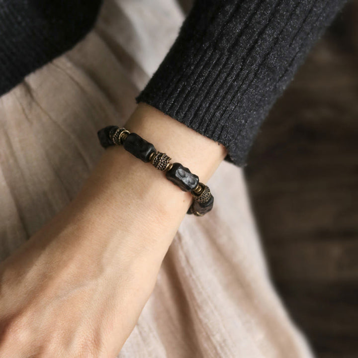 Bracelet tibétain en bois d'ébène et cuivre avec Buddha Stones pour la paix et le calme