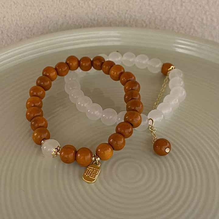 Bracelet de protection à breloques en bois de santal et œil de chat Fu avec Buddha Stones