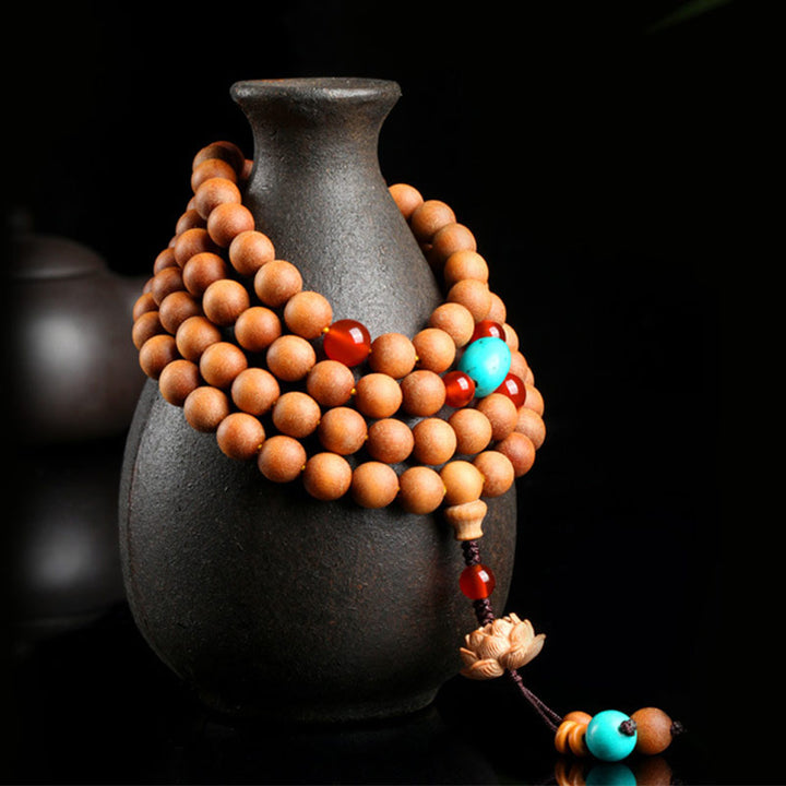 Bracelet Mala à breloques tibétaines en bois de santal et lotus avec Buddha Stones