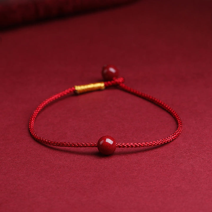 Bracelet en fil rouge avec bénédiction en agate rouge cinabre naturelle de Buddha Stones
