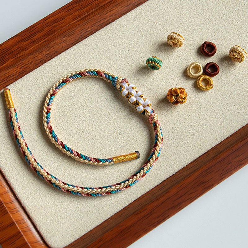 Bracelet tressé fait main en Buddha Stones avec motif de fleur de pêcher de couleur Dunhuang