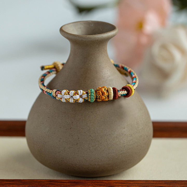 Bracelet tressé fait main en Buddha Stones avec motif de fleur de pêcher de couleur Dunhuang