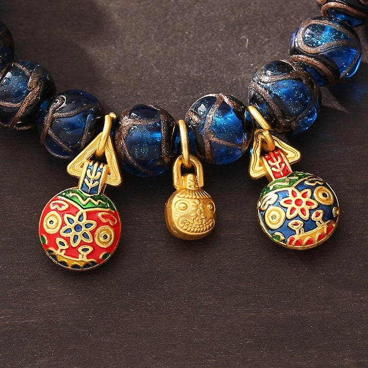 Bracelet porte-bonheur en perles de verre Liuli bleues avec Buddha Stones et bête avaleuse en or