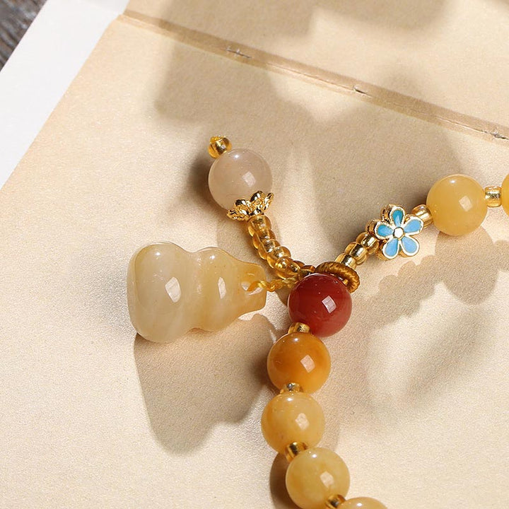Bracelet porte-bonheur en jade doré et soie naturelle Buddha Stones