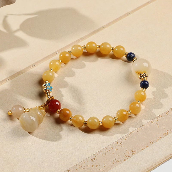 Bracelet porte-bonheur en jade doré et soie naturelle Buddha Stones