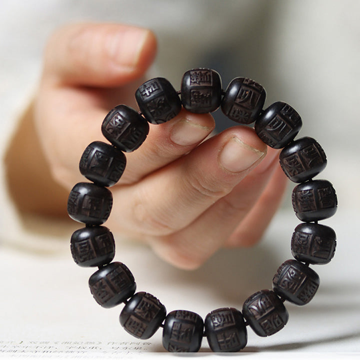 Bracelet d'équilibre gravé en bois d'ébène du Tibet Buddha Stones Om Mani Padme Hum