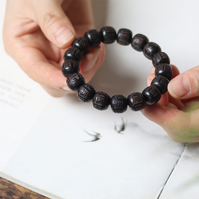 Bracelet d'équilibre gravé en bois d'ébène du Tibet Buddha Stones Om Mani Padme Hum