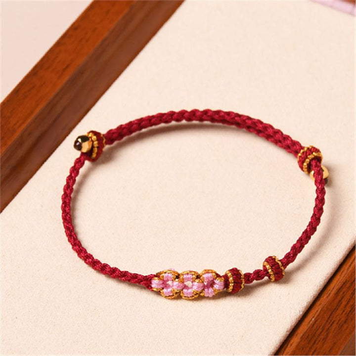 Bracelet tressé en corde de protection en fleur de pêcher fait main par Buddha Stones