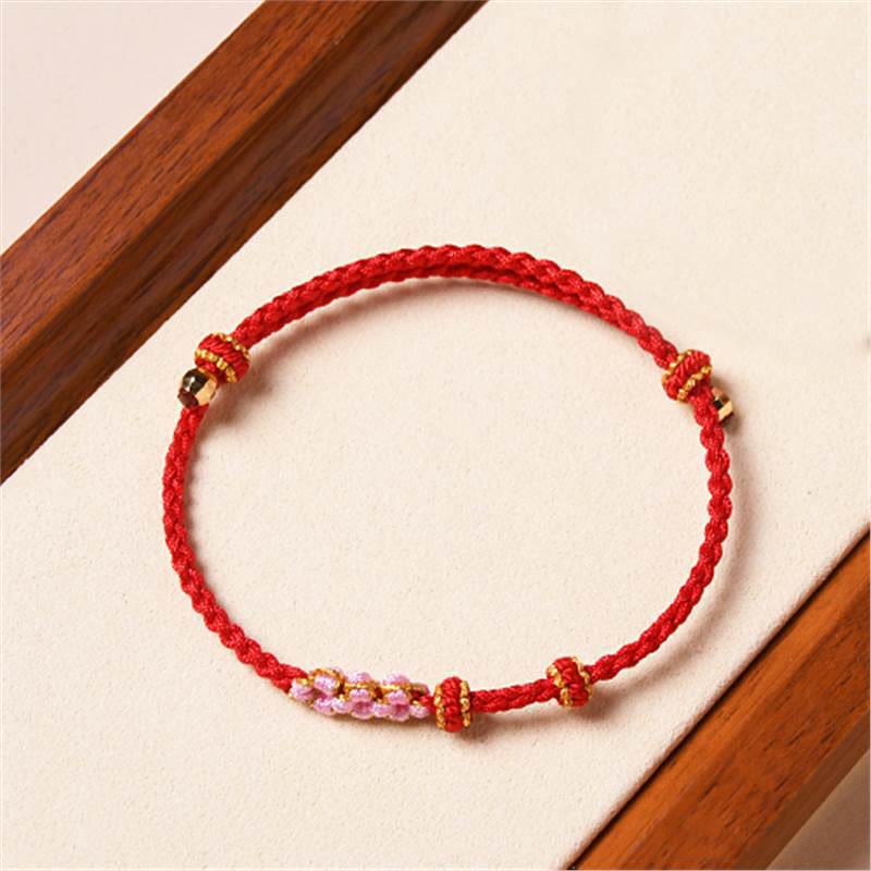 Bracelet tressé en corde de protection en fleur de pêcher fait main par Buddha Stones