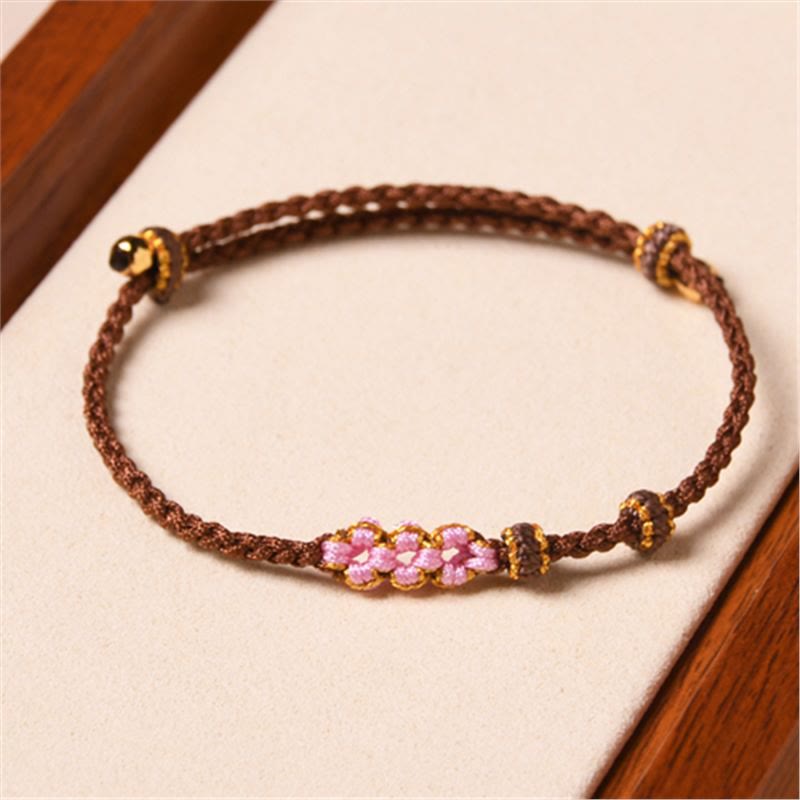 Bracelet tressé en corde de protection en fleur de pêcher fait main par Buddha Stones